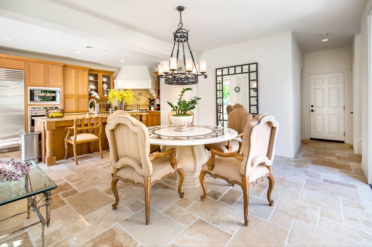 Formal dining beneath iron chandelier